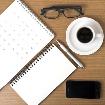 coffee,phone,eyeglasses,notepad and canlendar on wood table background