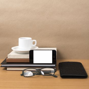 coffee,phone,eyeglasses,stack of book and wallet on wood table background