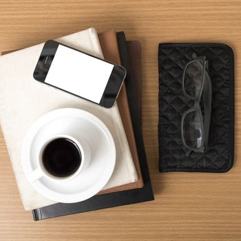 coffee,phone,eyeglasses,stack of book and wallet on wood table background