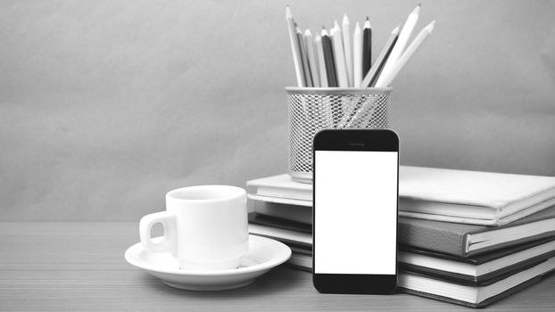 coffee,phone,stack of book and color pencil on wood table background black and white color