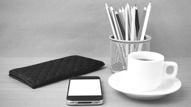 coffee,phone,wallet and color pencil on wood table background black and white color