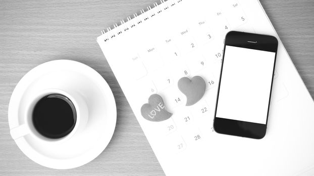 coffee,phone,calendar and heart on wood table background black and white color