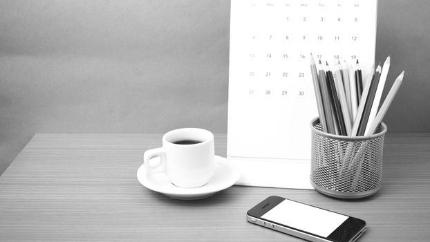 coffee,phone,calendar and color pencil on wood table background black and white color