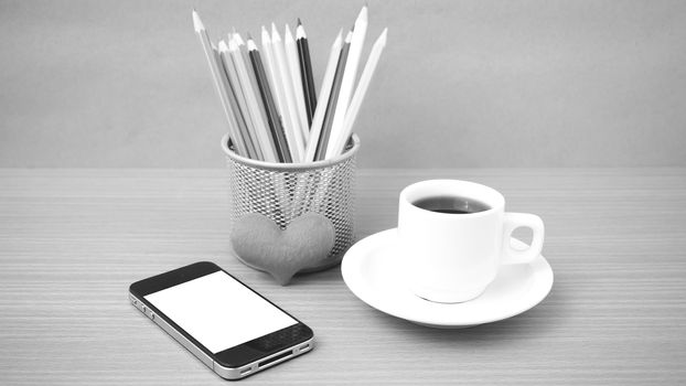 coffee,phone,color pencil and heart on wood table background black and white color