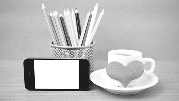coffee,phone,color pencil and heart on wood table background black and white color