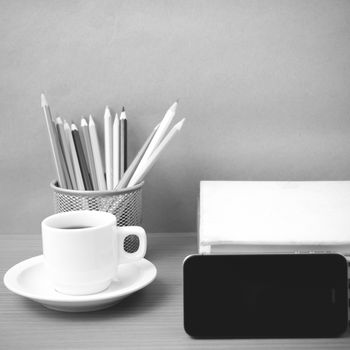 coffee,phone,stack of book and color pencil on wood table background black and white color