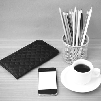 coffee,phone,wallet and color pencil on wood table background black and white color