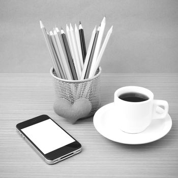 coffee,phone,color pencil and heart on wood table background black and white color