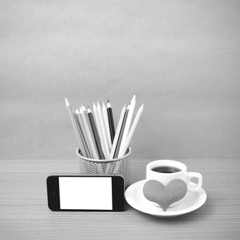 coffee,phone,color pencil and heart on wood table background black and white color