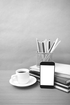 coffee,phone,stack of book and color pencil on wood table background black and white color