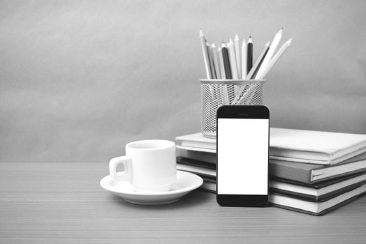 coffee,phone,stack of book and color pencil on wood table background black and white color
