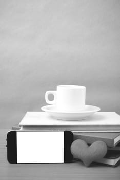 coffee,phone,stack of book and heart on wood table background black and white color