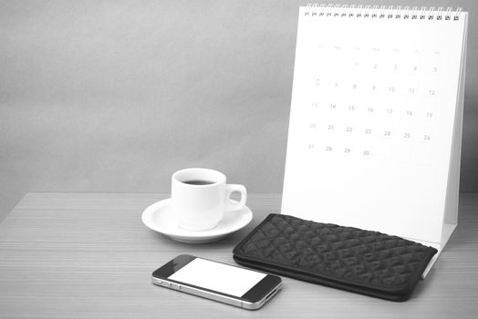 coffee,phone,wallet and canlendar on wood table background black and white color