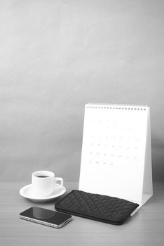 coffee,phone,wallet and canlendar on wood table background black and white color