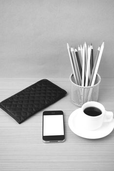 coffee,phone,wallet and color pencil on wood table background black and white color