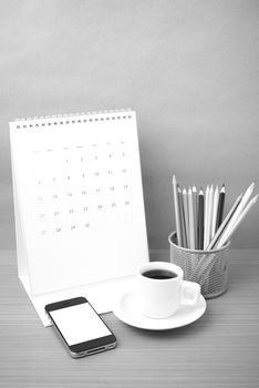 coffee,phone,calendar and color pencil on wood table background black and white color