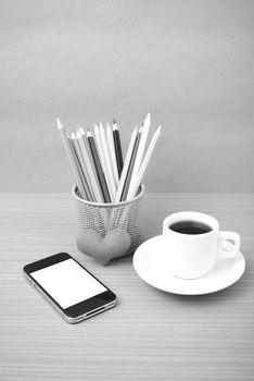 coffee,phone,color pencil and heart on wood table background black and white color