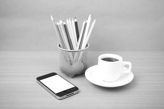 coffee,phone,color pencil and heart on wood table background black and white color