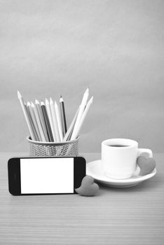 coffee,phone,color pencil and heart on wood table background black and white color