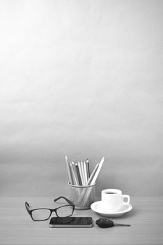 coffee,phone,eyeglasses,color pencil and car key on wood table background black and white color