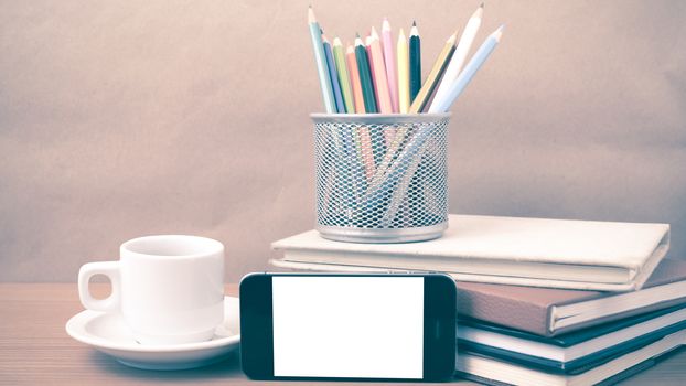 coffee,phone,stack of book and color pencil on wood table background vintage style