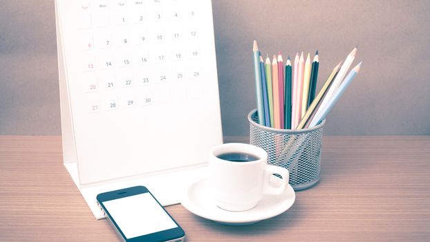 coffee,phone,calendar and color pencil on wood table background vintage style