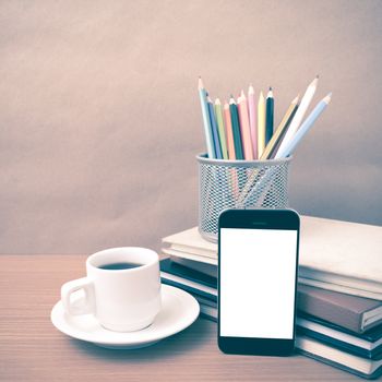 coffee,phone,stack of book and color pencil on wood table background vintage style