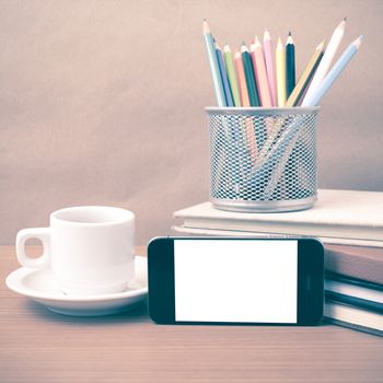 coffee,phone,stack of book and color pencil on wood table background vintage style