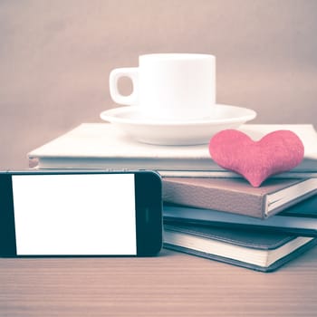 coffee,phone,stack of book and heart on wood table background vintage style