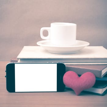 coffee,phone,stack of book and heart on wood table background vintage style