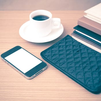 coffee,phone,stack of book and wallet on wood table background vintage style