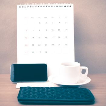 coffee,phone,wallet and canlendar on wood table background vintage style