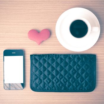 coffee,phone,wallet and heart on wood table background vintage style