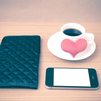 coffee,phone,wallet and heart on wood table background vintage style