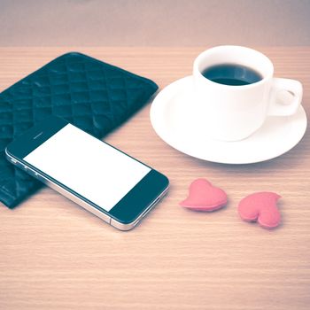 coffee,phone,wallet and heart on wood table background vintage style