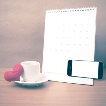 coffee,phone,calendar and heart on wood table background vintage style