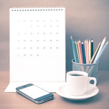 coffee,phone,calendar and color pencil on wood table background vintage style