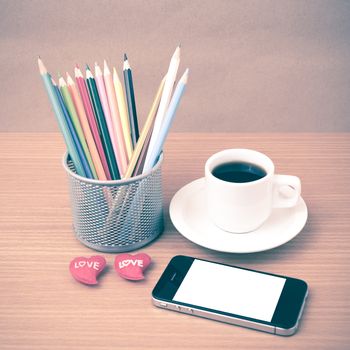 coffee,phone,color pencil and heart on wood table background vintage style