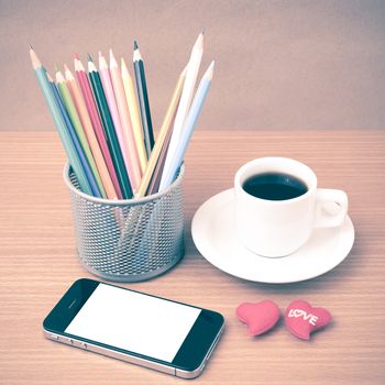 coffee,phone,color pencil and heart on wood table background vintage style