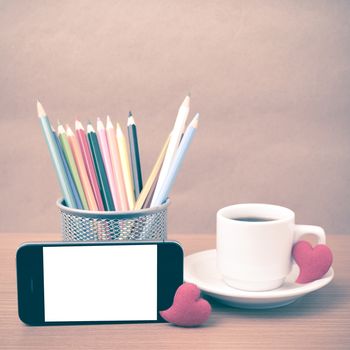 coffee,phone,color pencil and heart on wood table background vintage style