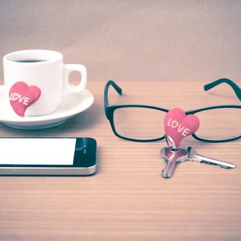 coffee,phone,eyeglasses and key on wood table background vintage style