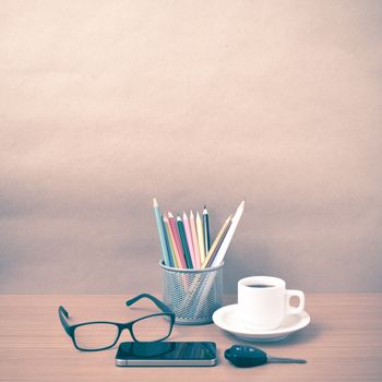 coffee,phone,eyeglasses,color pencil and car key on wood table background vintage style