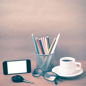 coffee,phone,eyeglasses,color pencil and car key on wood table background vintage style