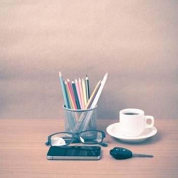 coffee,phone,eyeglasses,color pencil and car key on wood table background vintage style