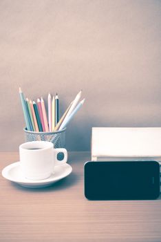 coffee,phone,stack of book and color pencil on wood table background vintage style