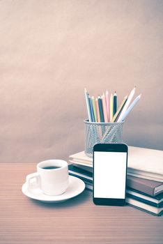 coffee,phone,stack of book and color pencil on wood table background vintage style