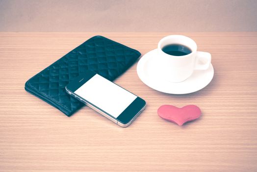 coffee,phone,wallet and heart on wood table background vintage style