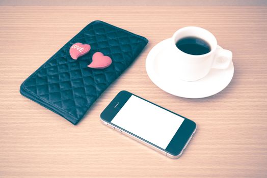 coffee,phone,wallet and heart on wood table background vintage style