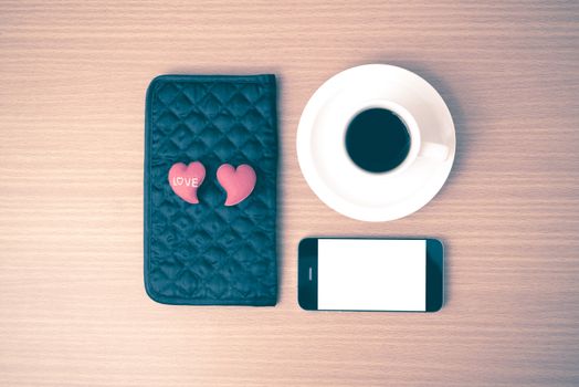 coffee,phone,wallet and heart on wood table background vintage style