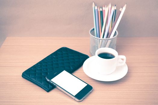 coffee,phone,wallet and color pencil on wood table background vintage style